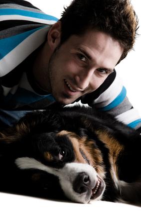 Young adult male with his dog on a white background