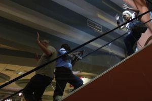 551821-a-police-officer-secures-an-area-as-civilians-flee-inside-westgate-shopping-centre-in-nairobi