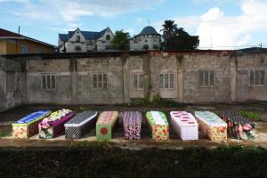 Ebony G. Patterson  9 of 219, Installed in a Yard in Port-of-Spain, Trinidad, Multi-Media Perfmative Project with Embellished Coffins ( 6ft x2ft x12 in) with Sound, 2011, Image Coutersy of Rodell Warner