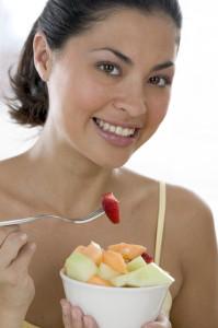 Woman Eating a Bowl of Fruit