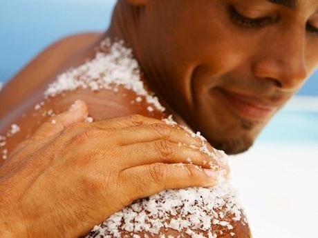 Hand Rubbing Bath Salt on Man's Shoulder