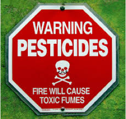 A sign warning about potential pesticide exposure.