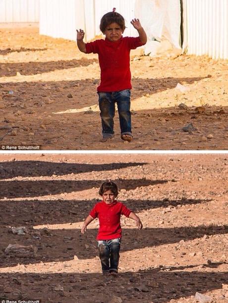 Syrian child mistakes a photographers camera for a weapon and raises her hands to 'surrender'