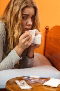 Femme malade se réchauffant avec un thé