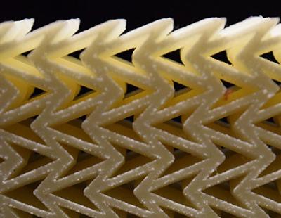 Photograph of the helmet material showing layers of arrow-shaped elements