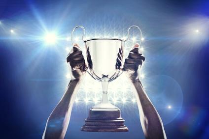 Composite image of cropped hand of athlete holding trophy_91658382_XS