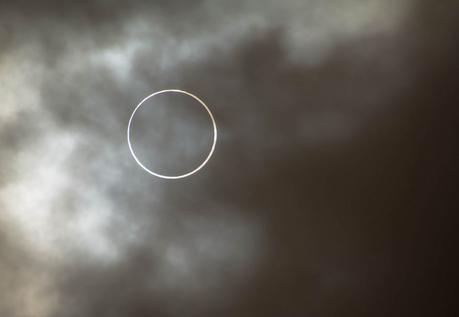 Menaçant, le voile nuageux ne fut pas assez épais pour occulter l’éclipse annulaire du Soleil, à la Réunion. Le disque lunaire est quasi centré sur celui de l’astre du jour. On peut distinguer les aspérités du relief sur le limbe de notre satellite. © Dave Pot, Flickr
