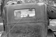 John Vachon - Migrant boy looking out of back window of auto. Berrien County, Michigan. July 1940.
