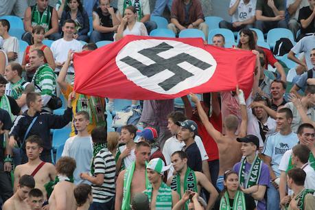 In this photo taken Aug. 19, 2007 soccer fans show German Nazi flag with a swastika during an Ukrainian League Championship soccer match between Dynamo Kyiv and Karpaty in Kiev, Ukraine. Kiev and Warsaw on Tuesday May 29, 2012 decried a BBC report that portrayed Ukrainian and Polish soccer fans as racist ahead of next month's European championship as unfair, vowing that all foreign guests would be safe to attend matches in the two Eastern European countries. (AP Photo/Ukrinform)