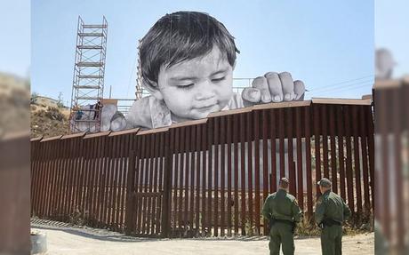 L’artiste JR installe une œuvre géante sur la frontière américano-mexicaine