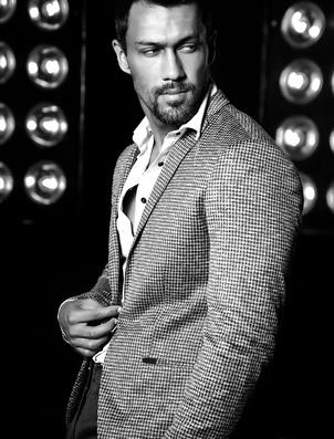 Portrait of sexy handsome fashion male model man dressed in elegant suit on black studio lights background123420636_XS