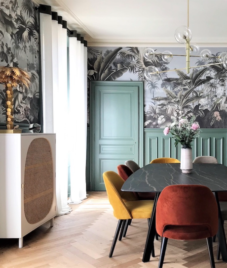 maison haussmannienne salle à manger table marbre noir fauteuil velours soubassements vert