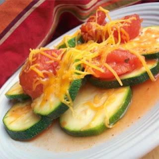 This classic comfort food consists of Mexican zucchini rounds simmered in stewed tomatoes, onions, and garlic then loaded with mild cheddar cheese.