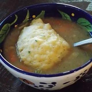 A delicious fluffy biscuit tops a light and flavorful chicken soup to create a classic American comfort food.