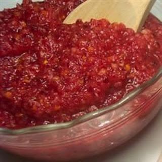 In this tart and tangy relish, cranberries and a whole orange are chopped in a blender or grinder and macerated in liqueur for several hours. Serve with turkey.